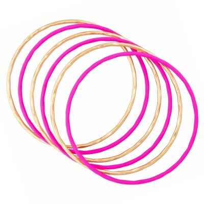 Gold and color coated bangles in hot pink front view.