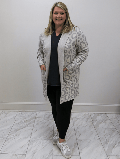 Jacquard cardigan front with worn with a grey shirt and black leggings.