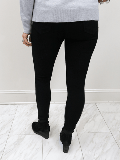 Just Black Denim black high rise skinny jean back view with black boots.