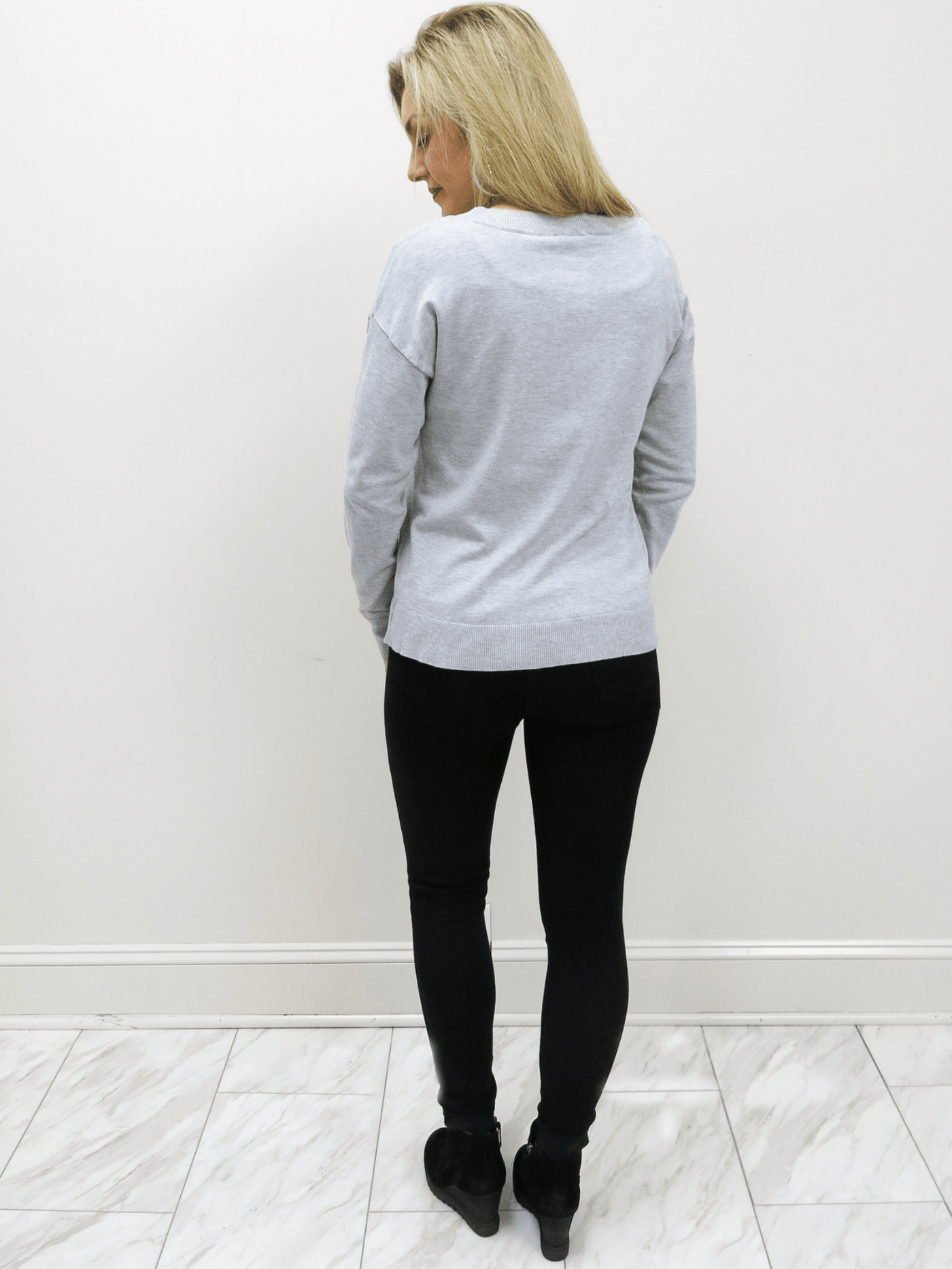 Just Black Denim black high rise skinny jean back view with black boots and Charlie Paige grey sweater.