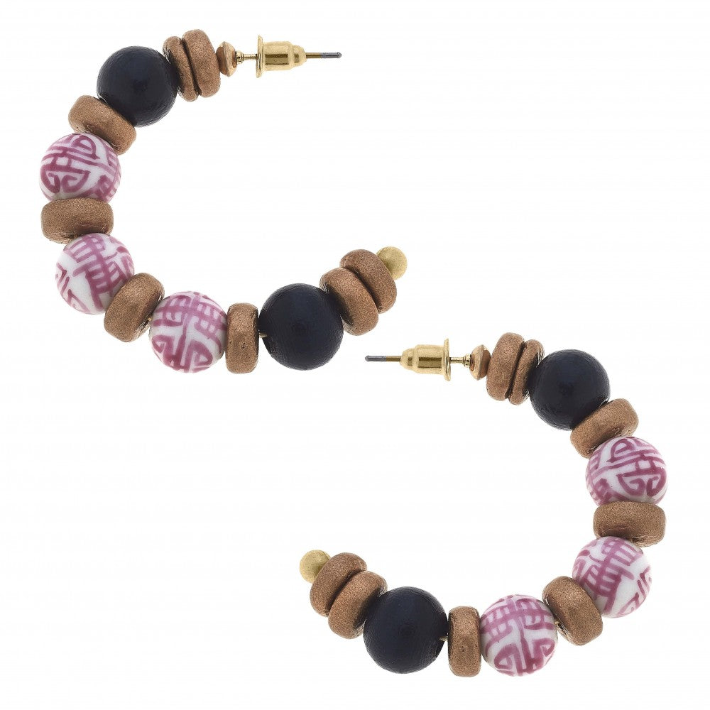 Pink chinoiserie bead with black and textured gold wood bead hoop earrings.