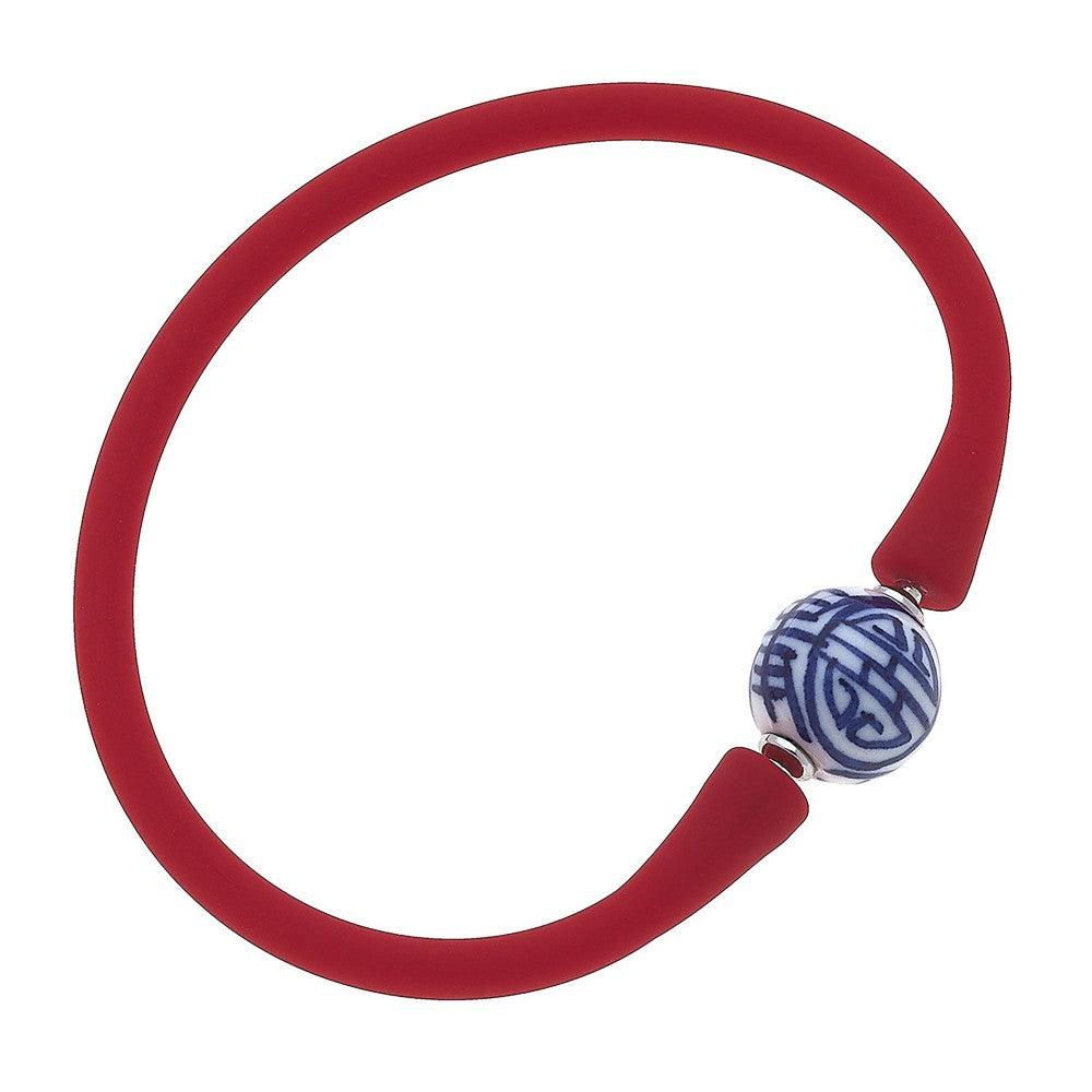 Dark red silicone bracelet with a small chinoiserie bead