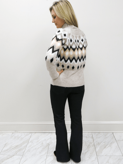 Risen coated black flare jeans with fair isle sweater back view.
