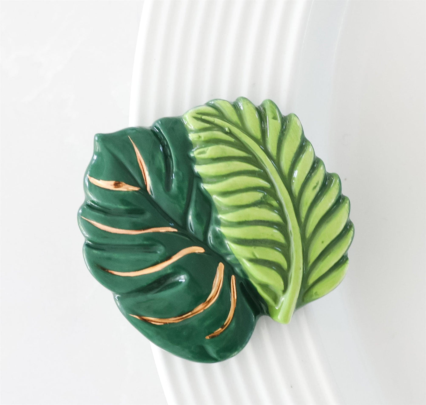 Dark green with gold accents fern leaf with a lime fern laid across it mini for a nora fleming dish