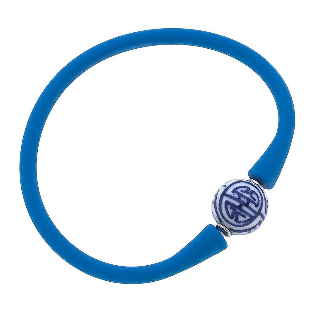 Blue silicone bracelet with a small chinoiserie bead