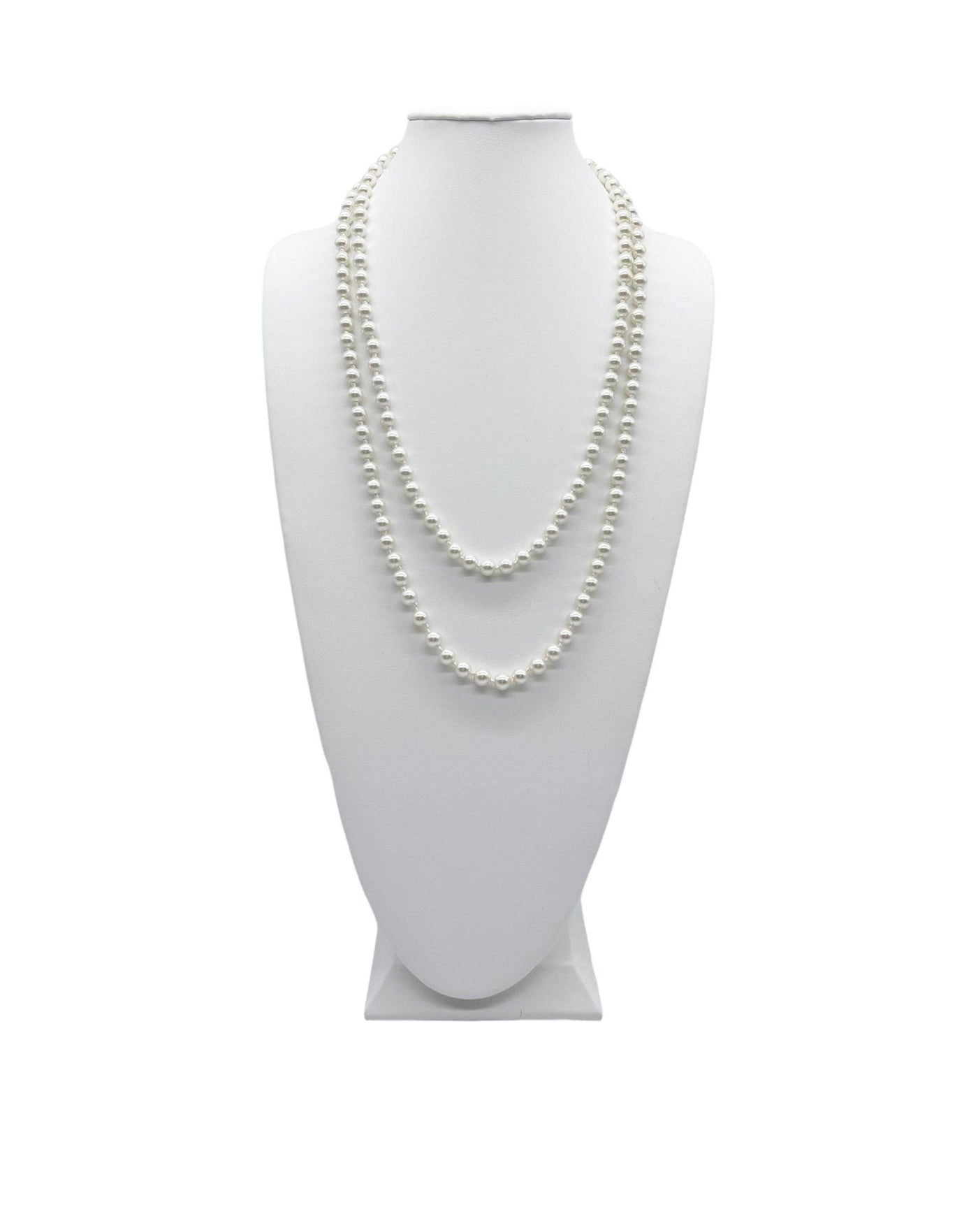 Long pearl necklace doubled up on a white neck display