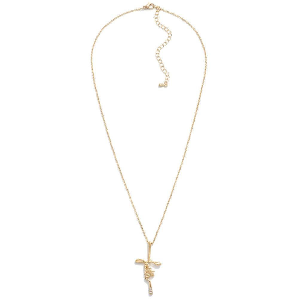 Cursive faith cross necklace with rhinestone accent in gold front view.