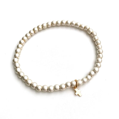White-gold beaded stretch bracelet with a luxe gold cross pendant