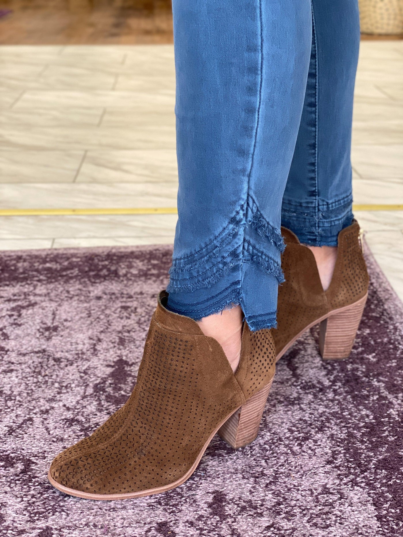 Frayed edge cuff denim pants in balsam paired with brown booties on 5'6" model.