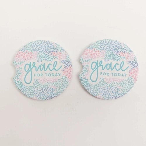 Car cupholder coasters with "grace for today" written in blue with blue, teal, purple, and pink spots all around