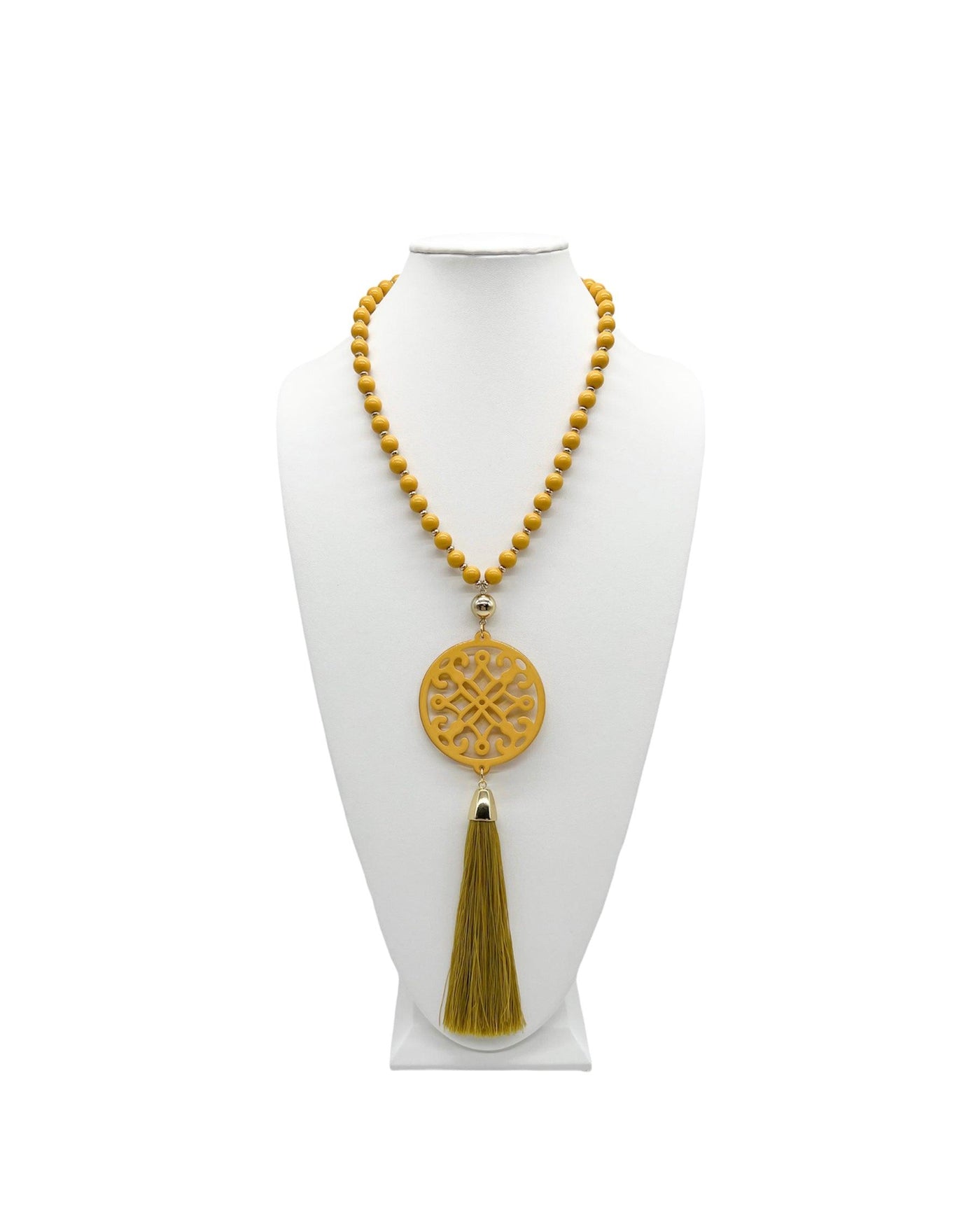 Honey yellow ornate resin pendant on a beaded chain with a rassel