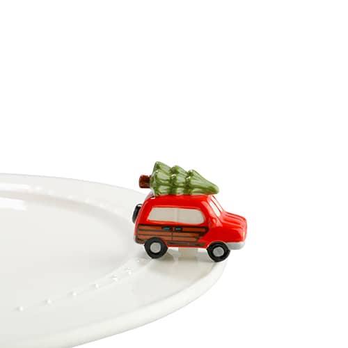 Vintage red station wagon with a Christmas tree on top for a Nora Fleming dish