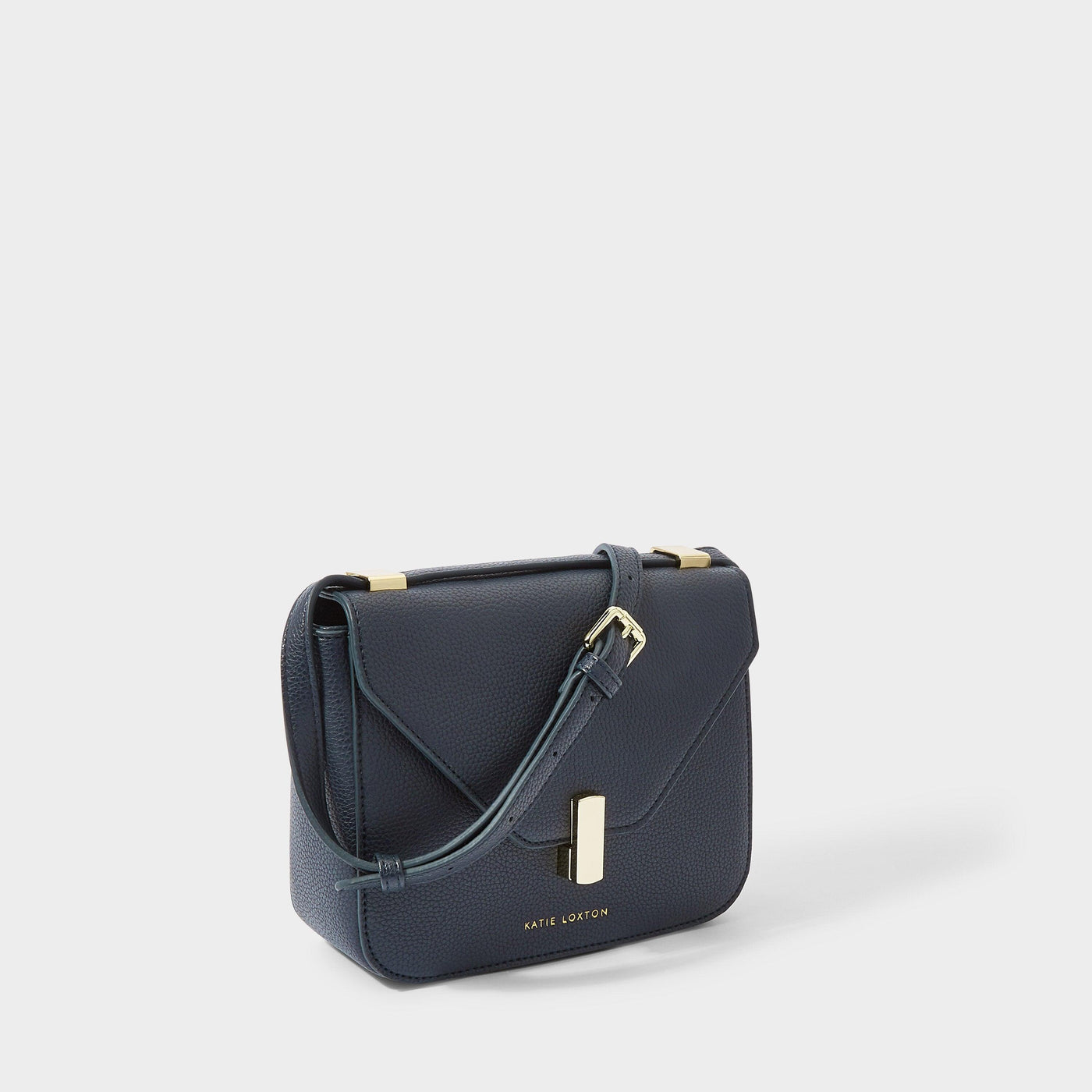 Navy flap closure crossbody purse with the strap draped over the front