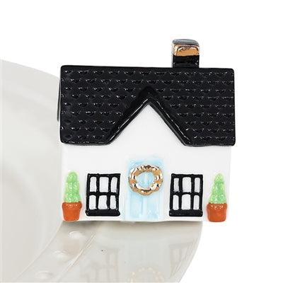 House figurine with blue door and little plants