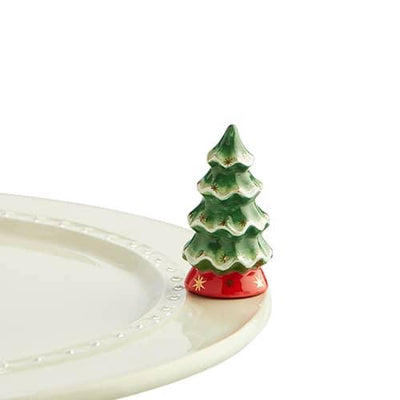 Tiny Christmas tree with little gold stars and a red tree skirt for a Nora Fleming dish