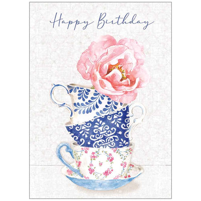 Off white birthday card with Happy Birthday, stacked tea cups and a big pink peony on the front