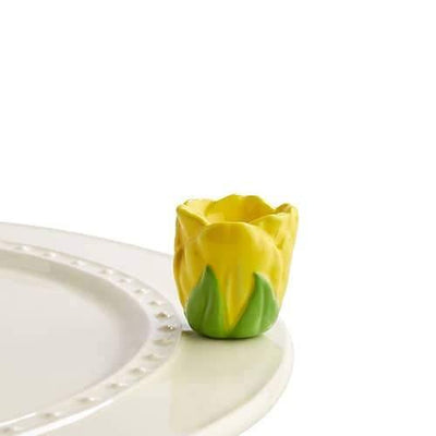Yellow tulip with green leaves for decorating a Nora Fleming dish