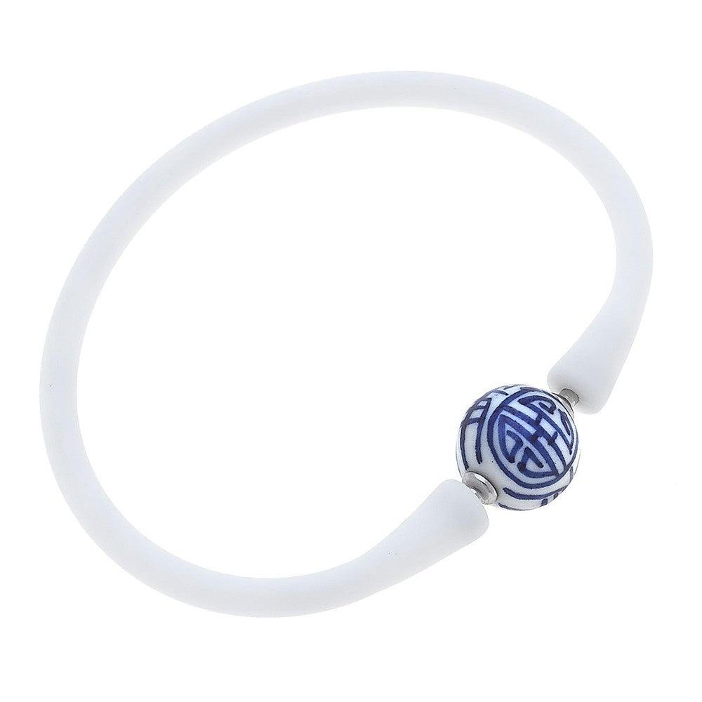 White silicone bracelet with a small chinoiserie bead